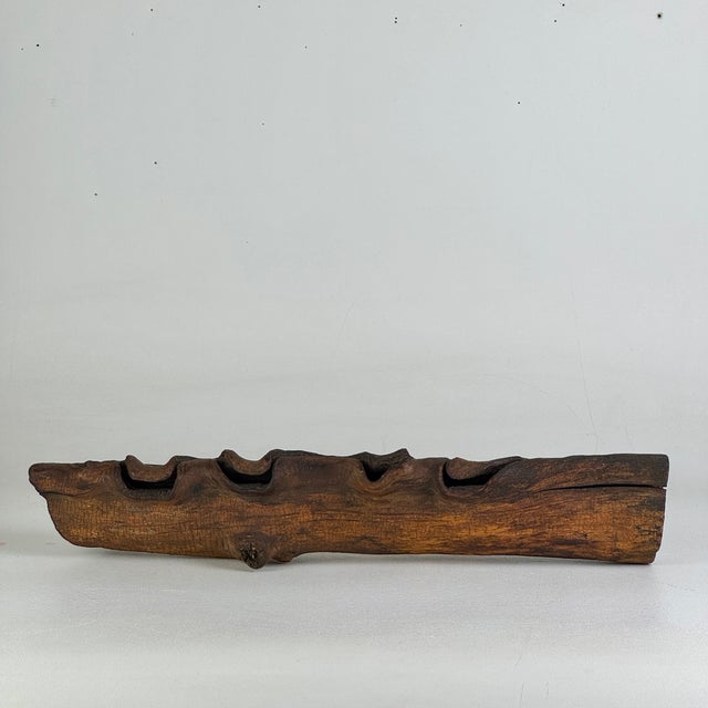 An unusually developed piece of branch of wood, which could have grown around a fence or cable or such. Or could this have...
