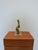 Brazilian modern abstract figurative sculpture of a person sitting rendered in bronze and attached to an acrylic base....