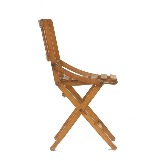 Iconic folding seat produced by "Fratelli Reguitti" in the 1950s Beech strips and metal details Branded production mark...