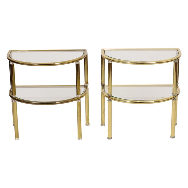 A lovely set of two semicircular side tables or nightstands made of gold- and silver-tone chrome metal and smoked glass;...