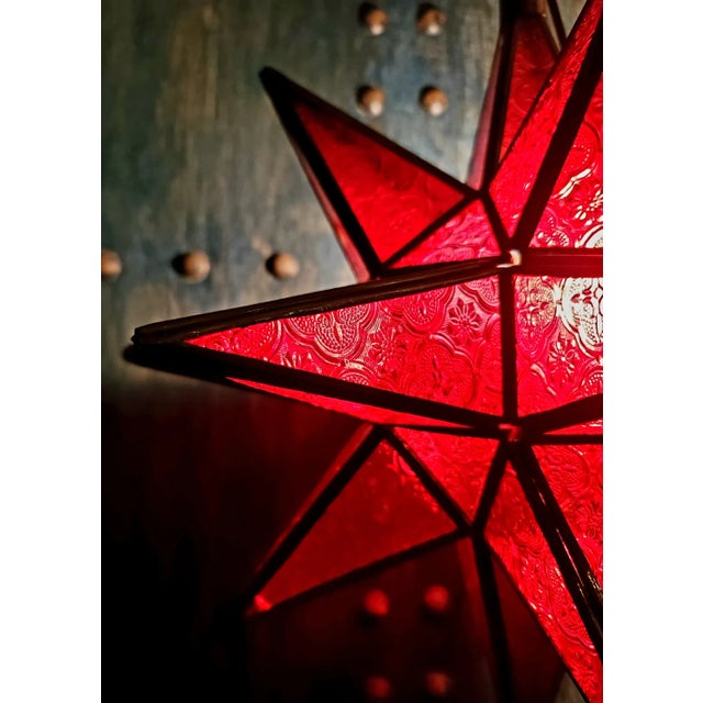 Handmade Moroccan Star glass lantern, also known as Moravian star. Aged metal frame and frosty red glass, measuring...