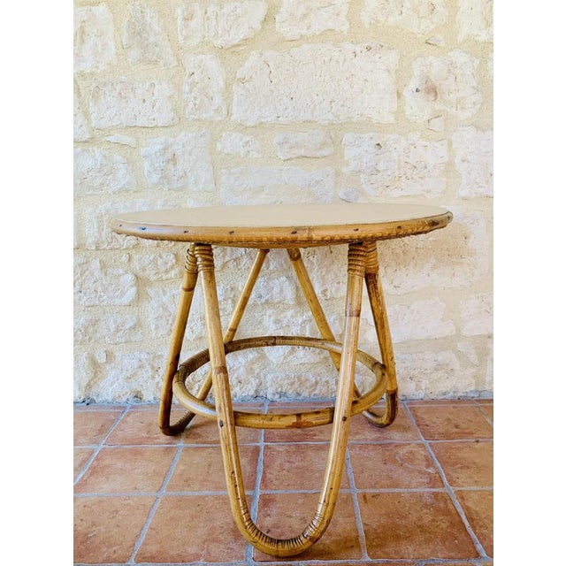 Mid-century, vintage, bamboo and rattan side table, with round tabletop on hairpin, tripod legs, circa 1960's. This piece,...