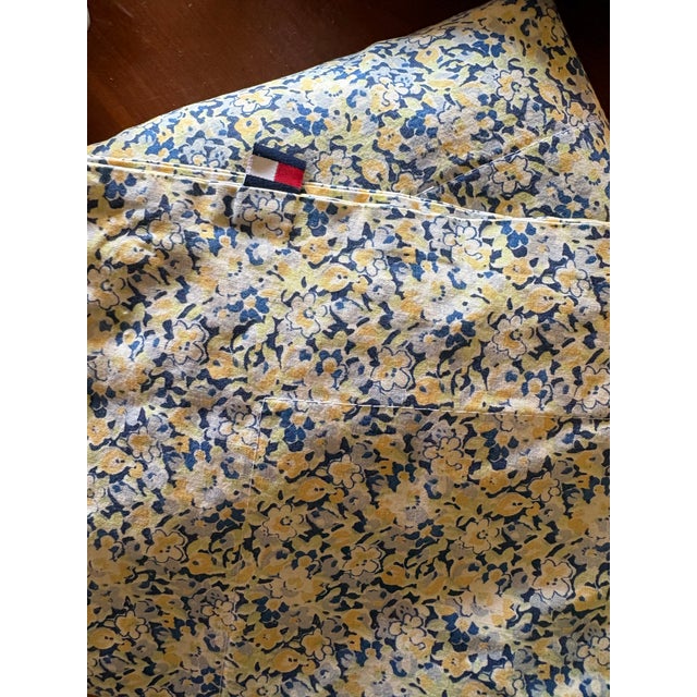 Blue background. Scattered ditsy daisies. Yellow and white accents. Cotton or cotton blend fabric. King sizes pillow...
