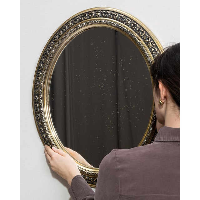 Here is a mirror, its gold/brass oval frame the first thing to catch the eye. Dating to 1880s and originating from France,...