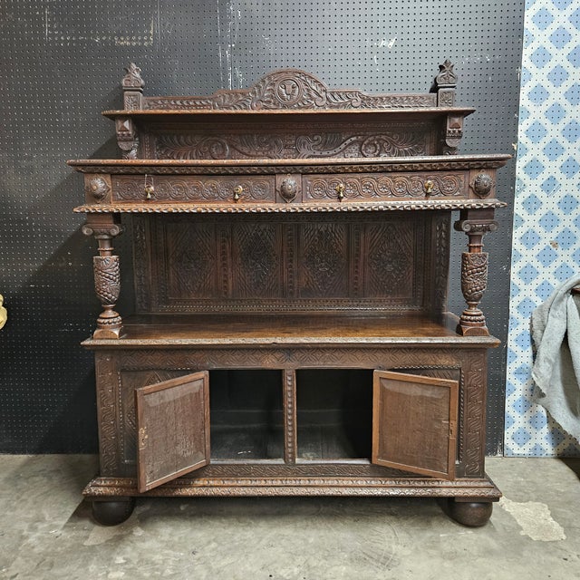 This Oak Carved buffetis a great serving piece for the dining room with storage below. It would also make a great coffee...