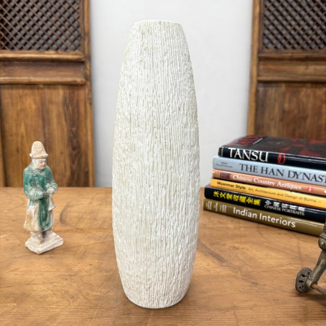 "About This Piece About This Piece Bring the quiet strength of nature indoors with this tall textured ceramic vase, a...