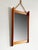 A wall mirror with a teak frame is for sale 1960s with leather strap suspension Mass HWD: 5.5 x 36.5 x 63 cm The object...