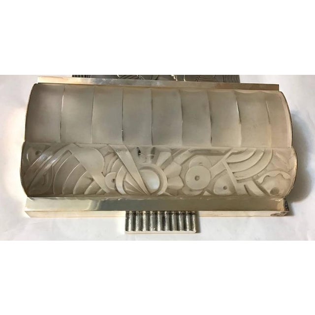 Stunning pair of French Art Deco sconces by Sabino. Having clear frosted molded glass shades enhanced by intricate...