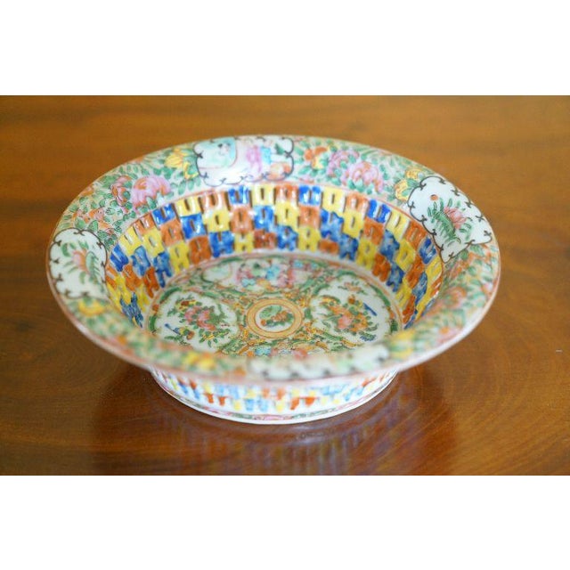 A decorative antique Chinese export famille rose reticulated porcelain basket bowl featuring pierced openwork sides,...