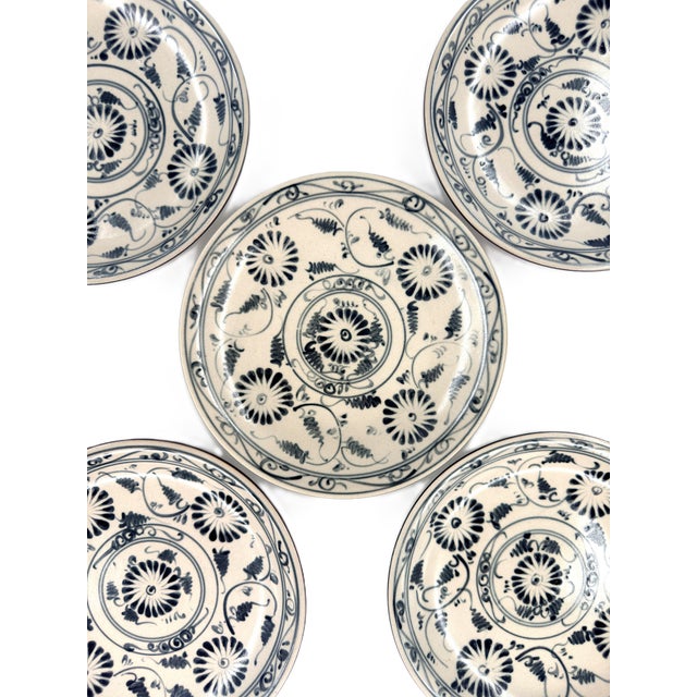 A beautiful set of five Bat Trang dessert plates, decorated in classic deep indigo blue over a warm ivory ceramic ground....