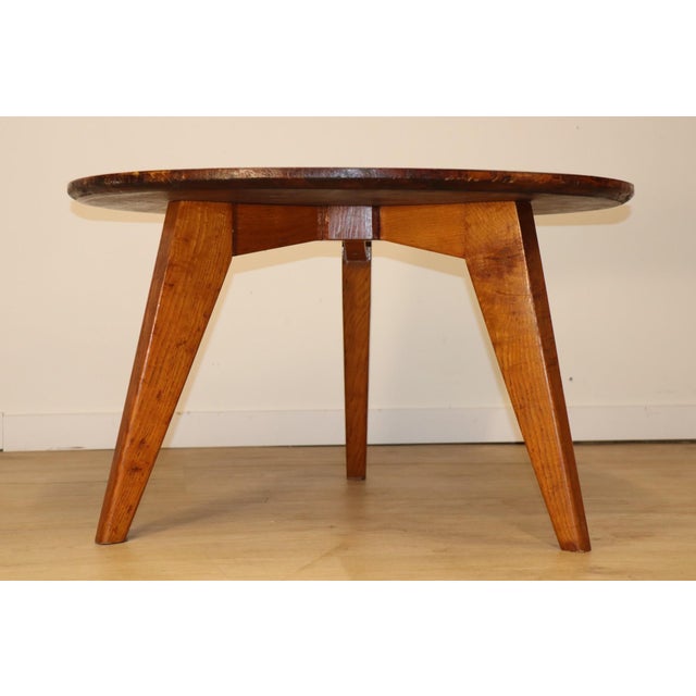 A beautiful 1950s tripod coffee table, crafted from solid oak, featuring a simple yet robust construction typical of...