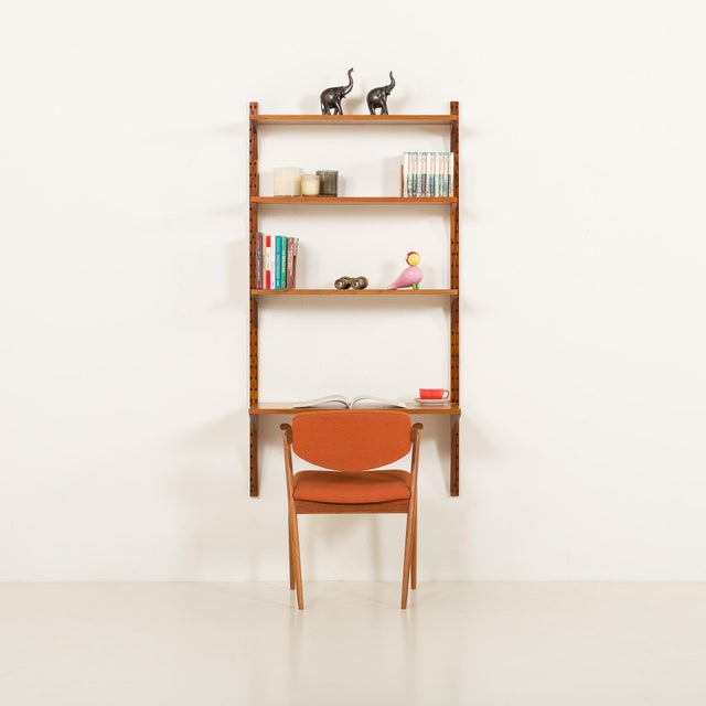This teak wall unit with a desk-shelf was designed by poul cadovius for his company cado in the 1960s. Its simple form...