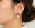 Elegant 14K gold and silver drop earrings featuring two natural carved amethysts paired with two lustrous baroque pearls....