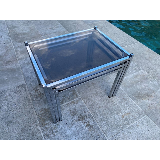 Very rare and beautiful set of three nesting coffee tables in very good condition Minimal signs of wear Chrome-plated...