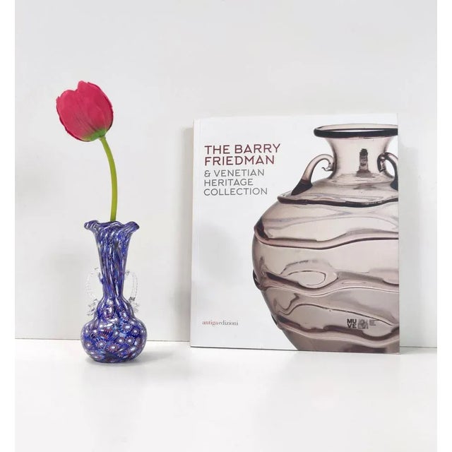 Made in Italy, 1960s. This is a blue Murano glass vase with a multitude of different murrines with blue, white and red...