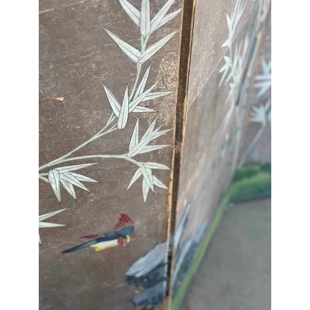 This stunning hand-painted Japanese four-panel screen features an elegant depiction of birds perched amidst bamboo...