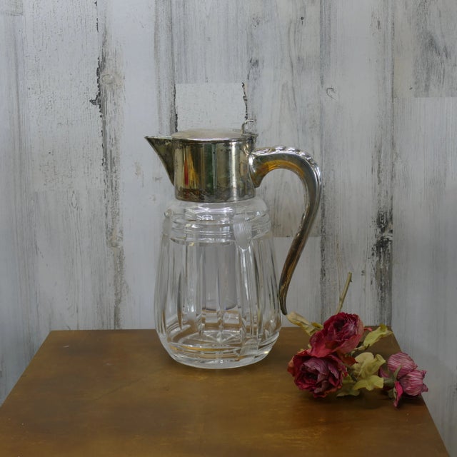 Gorgeous vintage crystal and silver-plate pitcher, with a removeable ice chamber. The ice holder sits recessed into the...