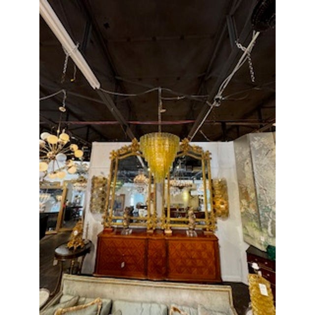 The Olive Green Murano Glass Waterfall Chandelier is a stunning and unique lighting fixture that adds a touch of elegance...