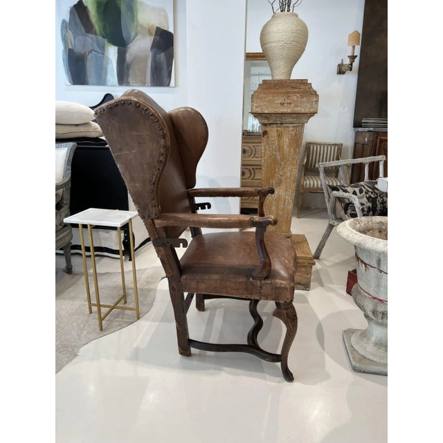 Rare early reclining chair in walnut with leather. Notched bracket allows back to recline in three positions.