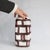 A striking signed Guido Gambone vase, where disciplined geometry meets the unmistakable warmth of the handmade. Its softly...