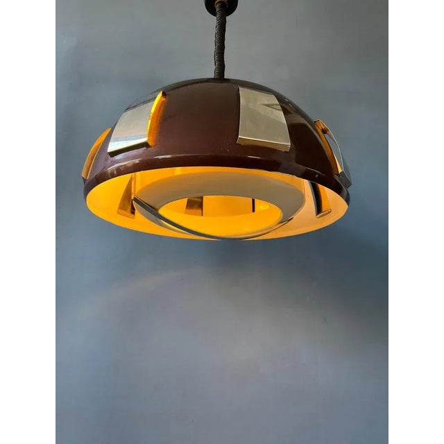 Mid-Century pendant light by Lakro Amstelveen. The lamp is made out of steel and has a dark brown/sparkle lacquer. The...