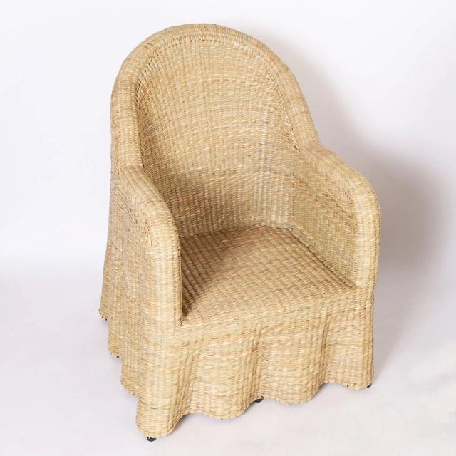 Chic midcentury inspired pair of ghost drapery armchairs handcrafted with a durable metal frame wrapped in reed with a...