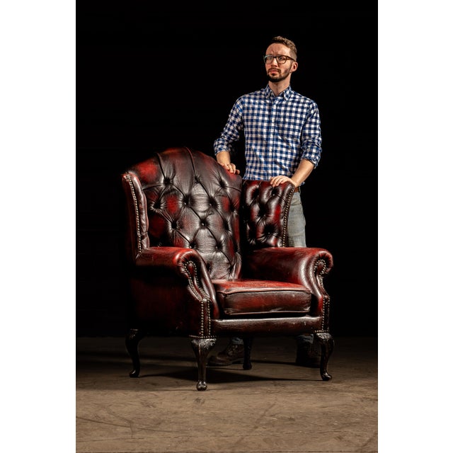 Vintage tufted leather armchair. This piece comes in a rich shade of red in two tones; light red on the surface gives way...