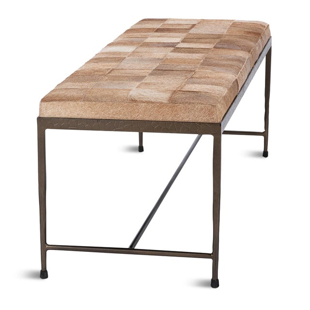 Modern beautiful hide upholstered bench in a square patchwork pattern of varying shades of tan. Bronze finish iron...