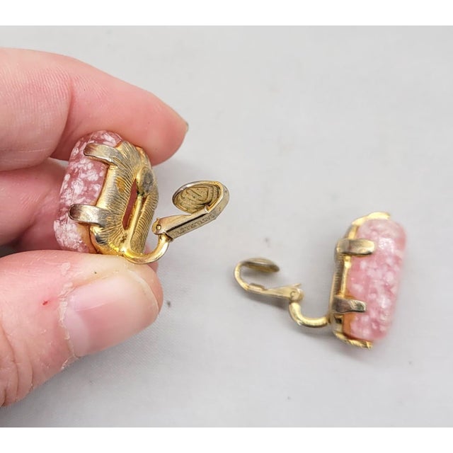 1960s goldtone and rectangular pink art glass clip earrings. Marked "CASTLECLIFF" on the clip backs. Measure: 7/8 inches...