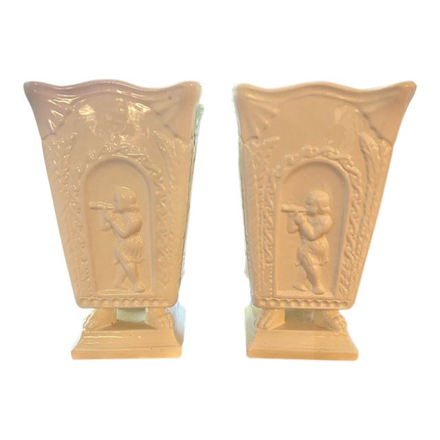 Late 20th Century Neoclassical Cream Ceramic Putti Pedestal Vases – A Pair For Sale