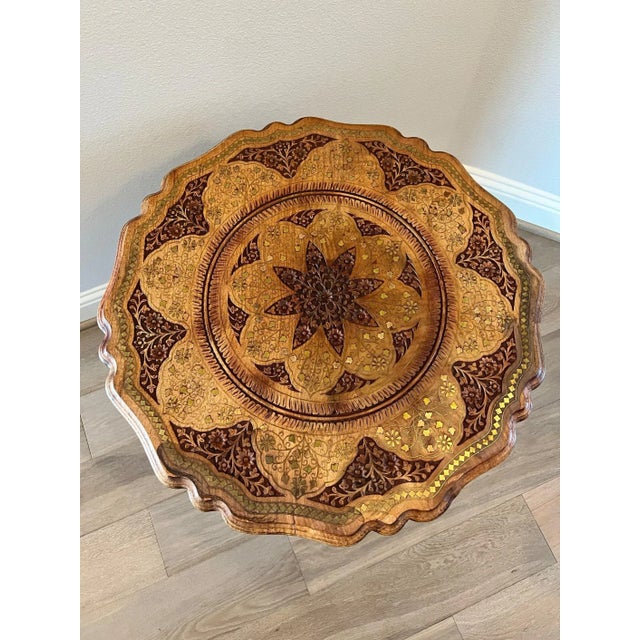 A vintage Anglo-Indian hand-carved solid wood round tripod pedestal end table with stunning brass inlay throughout. Hand-...