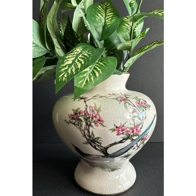 Beautiful vintage chinoiserie vase with a bird and pink flowering bush on 2 sides. Gold gilding along the bottom and top....