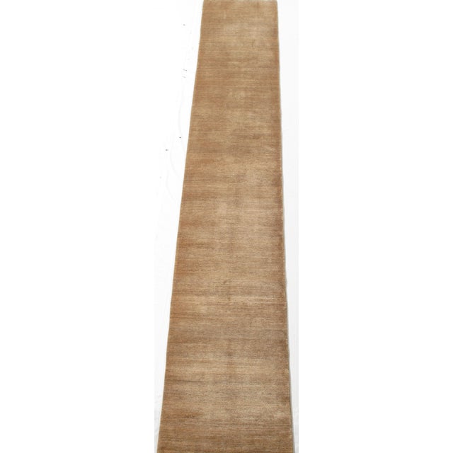 Vintage hand-knotted Persian Lori wool runner with a plain beige field and subtle tonal variation throughout. Minimalist...