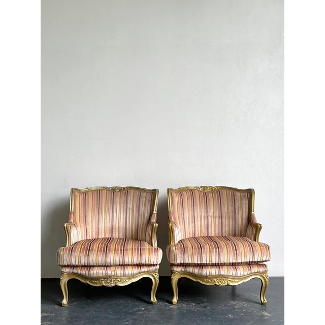 This exquisite pair of vintage French Bergère chairs epitomizes the refined elegance of early 20th-century Rococo-inspired...