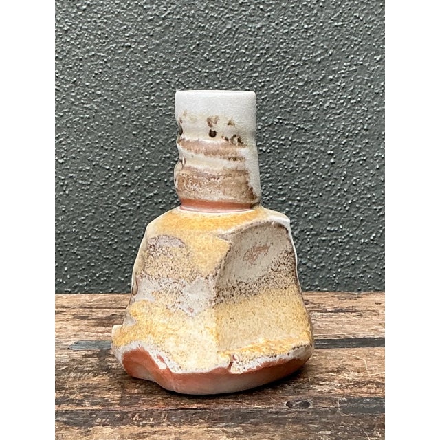 With its unique form and organic glaze, this vintage abstract ceramic vase presents a striking example of mid-century...