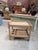 Antique solid oak serving cart. It features two grooved shelves, one of which includes a bottle rack and a grooved handle....