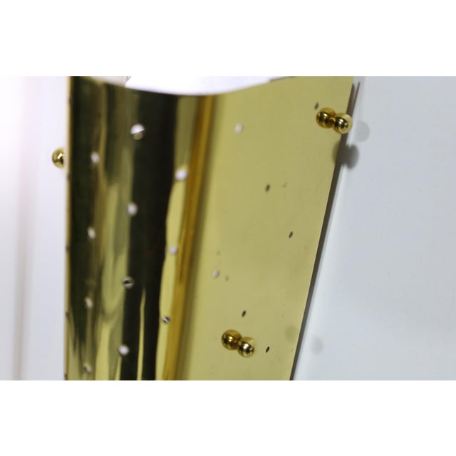 Unique style Italian wall sconces in pierced brass with Lucite. Sconces measure 31" high. Three brass rods pierce the...