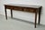 This elegant table was made in England. The table was made in solid oak with a beautiful grain pattern. It has a warm...