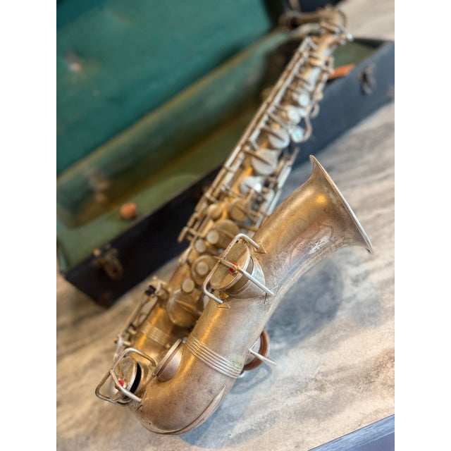 Vintage Wurlitzer Alto Saxophone with a classic silver-plated finish, made in the USA. This instrument features ornate...