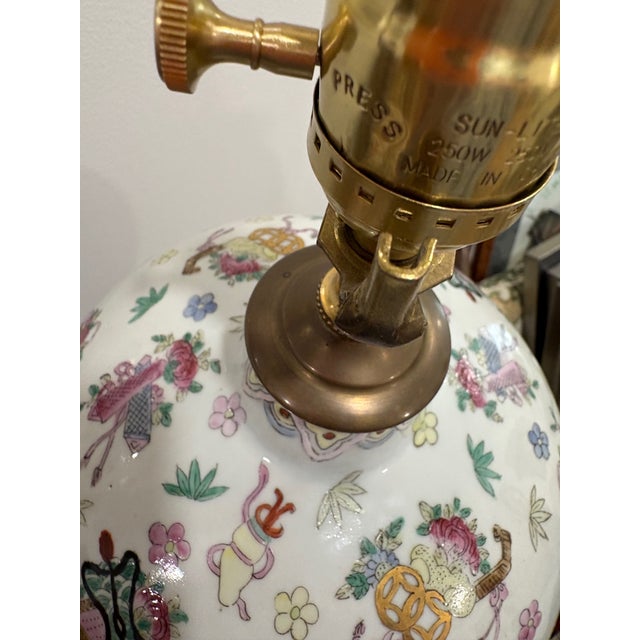 Large mid-century Chinese export lamp in a precious objects theme. Nice soft famille Rose color palette. Recently rewired...
