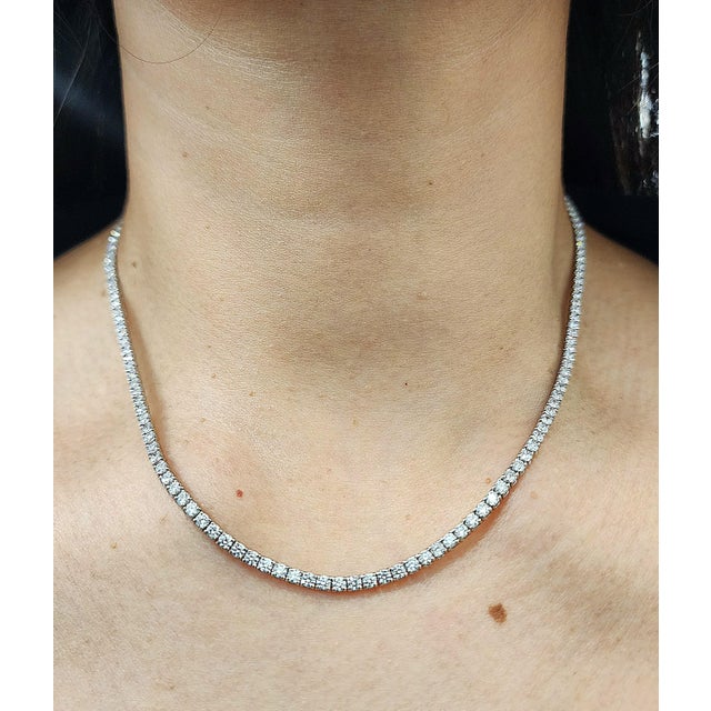 This exquisite tennis necklace showcases exceptional artistry and timeless elegance. Featuring approximately 9.00 carats...