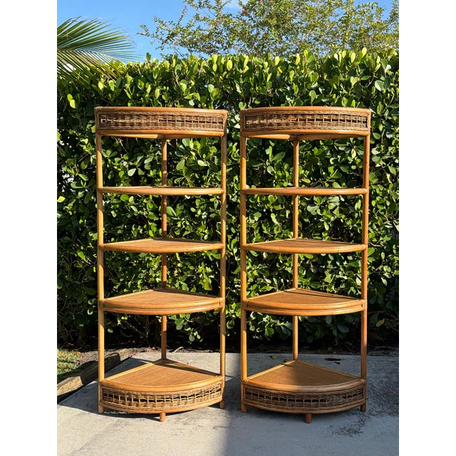 A striking pair of tall vintage woven rattan corner étagères with a warm honey finish and a clean, architectural...