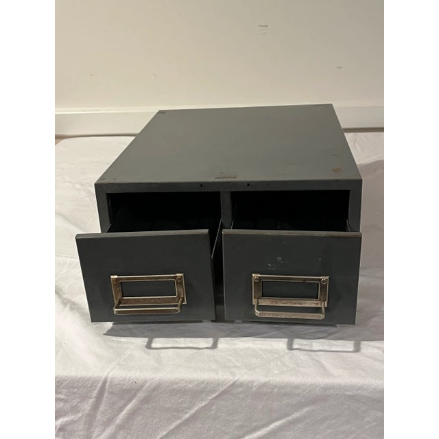 Vintage stackable metal cabinet with two drawers. Original gray paint with some rust; this versatile storage piece has a...