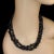 This striking 36-inch infinity necklace features highly polished hematite nuggets ranging in size from 6 mm to 12 mm,...