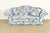 A gorgeous and very comfortable English Traditional floral upholstered roll arm camelback sofa or loveseat By Baker...
