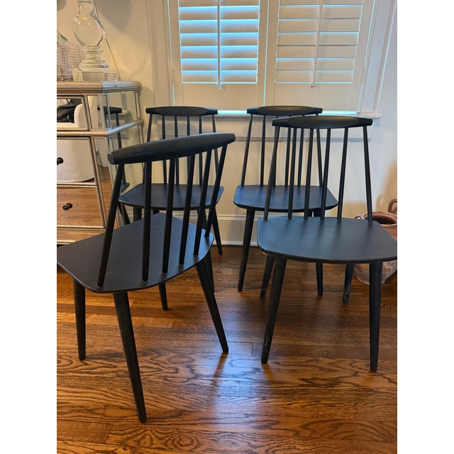 A handsome set of four vintage Danish Modern spindle-back dining chairs manufactured by FDB Møbler of Denmark. Each chair...