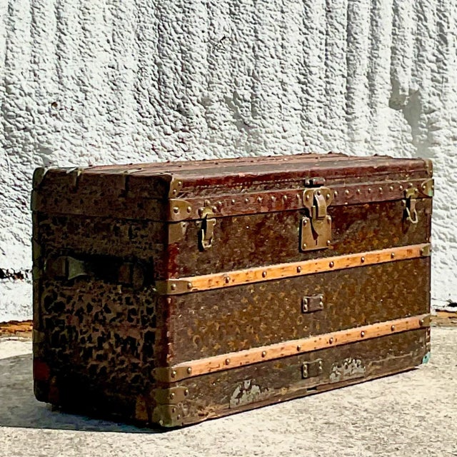 A spectacular vintage Boho Steamer trunk. Made by the prestigious Louis Vuitton group. All over patina from time and use....