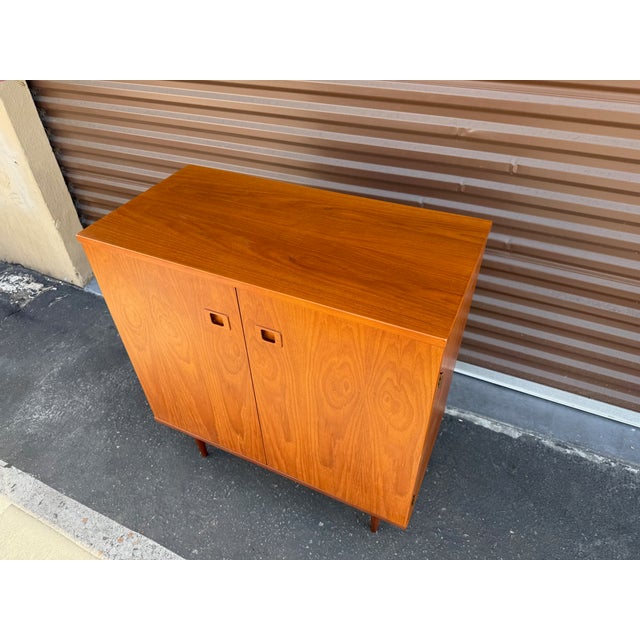 Authentic vintage Danish made teak cabinet from Hans Olsen. This Danish Modern beauty has 2 internal shelves. A great...