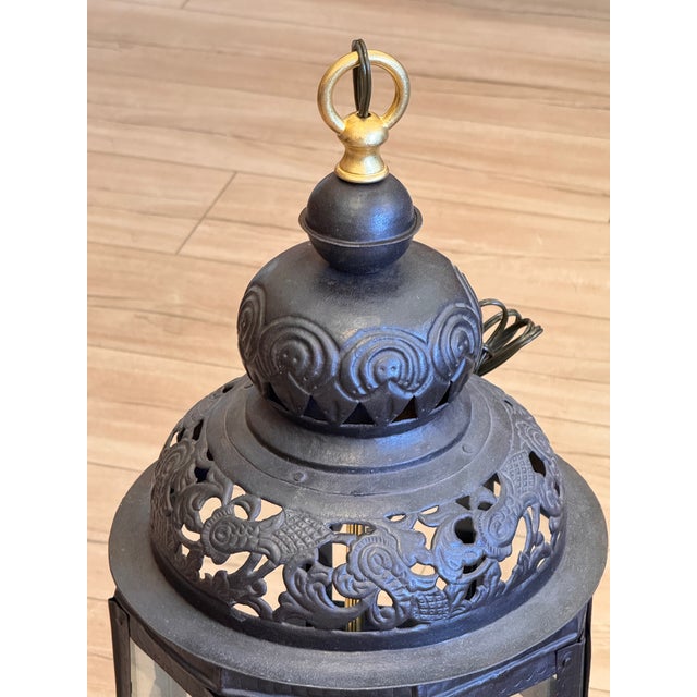 Pair of pierced metal octagonal lanterns, each with an eight-sided glazed body with flat glass panels set in riveted metal...