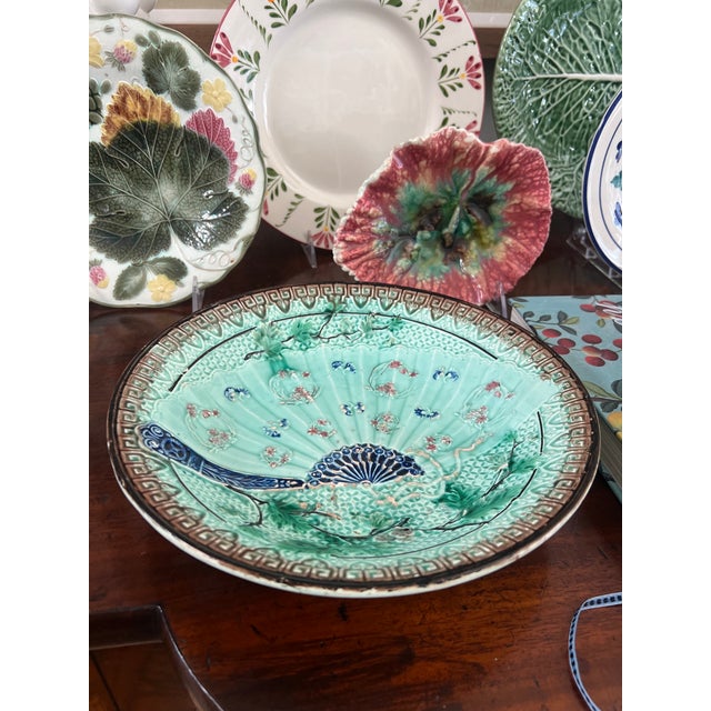 Antique majolica bowl made by Villeroy & Boch likely in their German factory. The turquoise bowl has a fan, flowers and a...